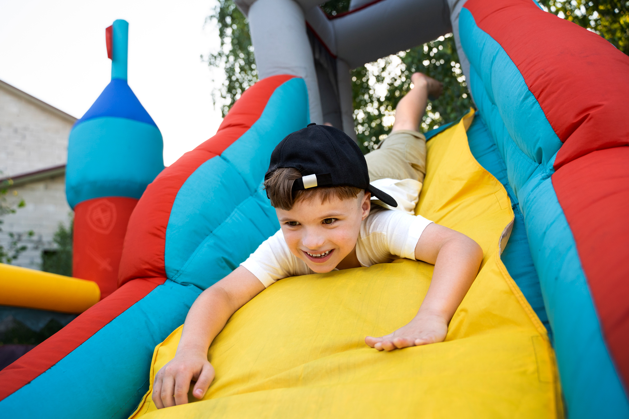 Child playing in bounce house at his birthday party